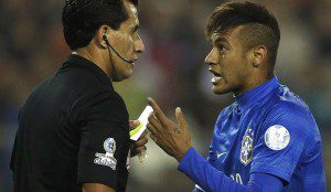 Brazil's Neymar argues with referee Enrique Osses after receiving a yellow card during the first round Copa America 2015 soccer match against Colombia at Estadio Monumental David Arellano in Santiago, Chile, June 17, 2015. REUTERS/Ivan Alvarado